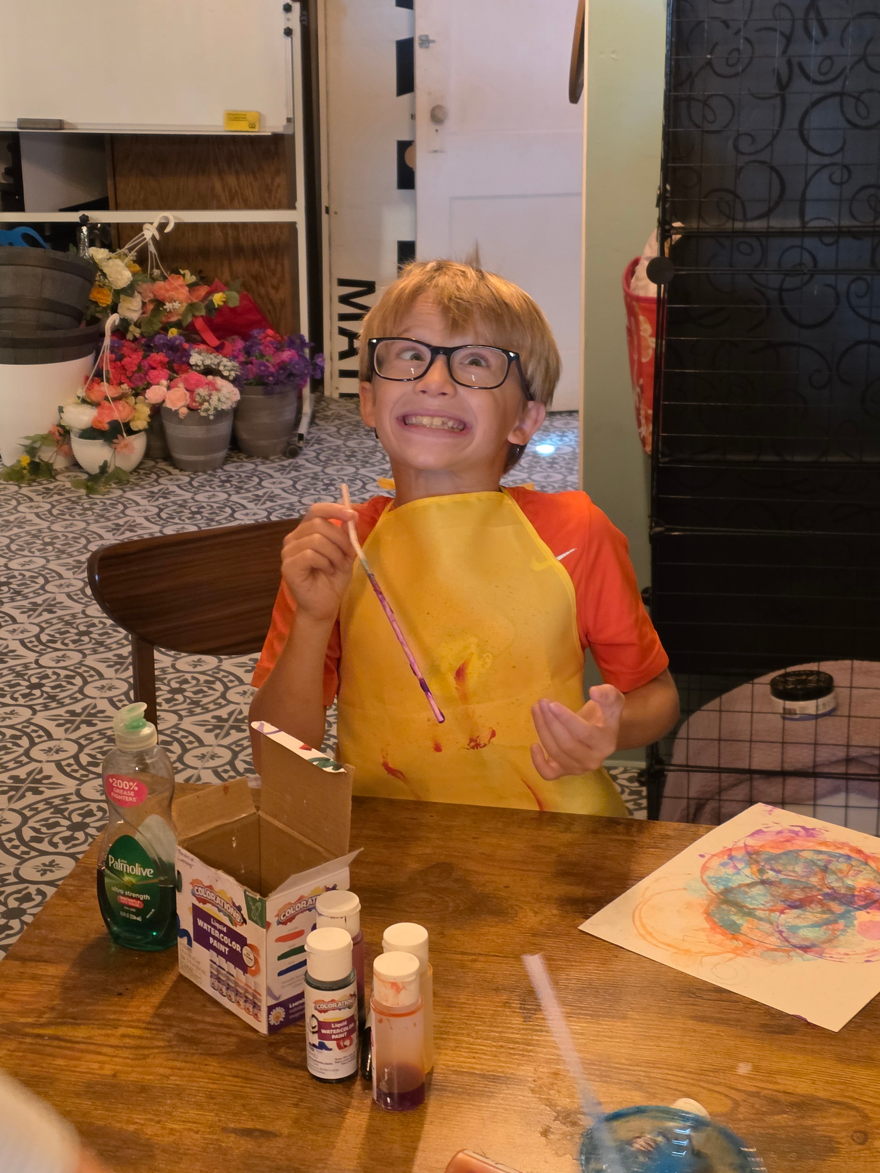 Student smiling while painting at Focus Microschool