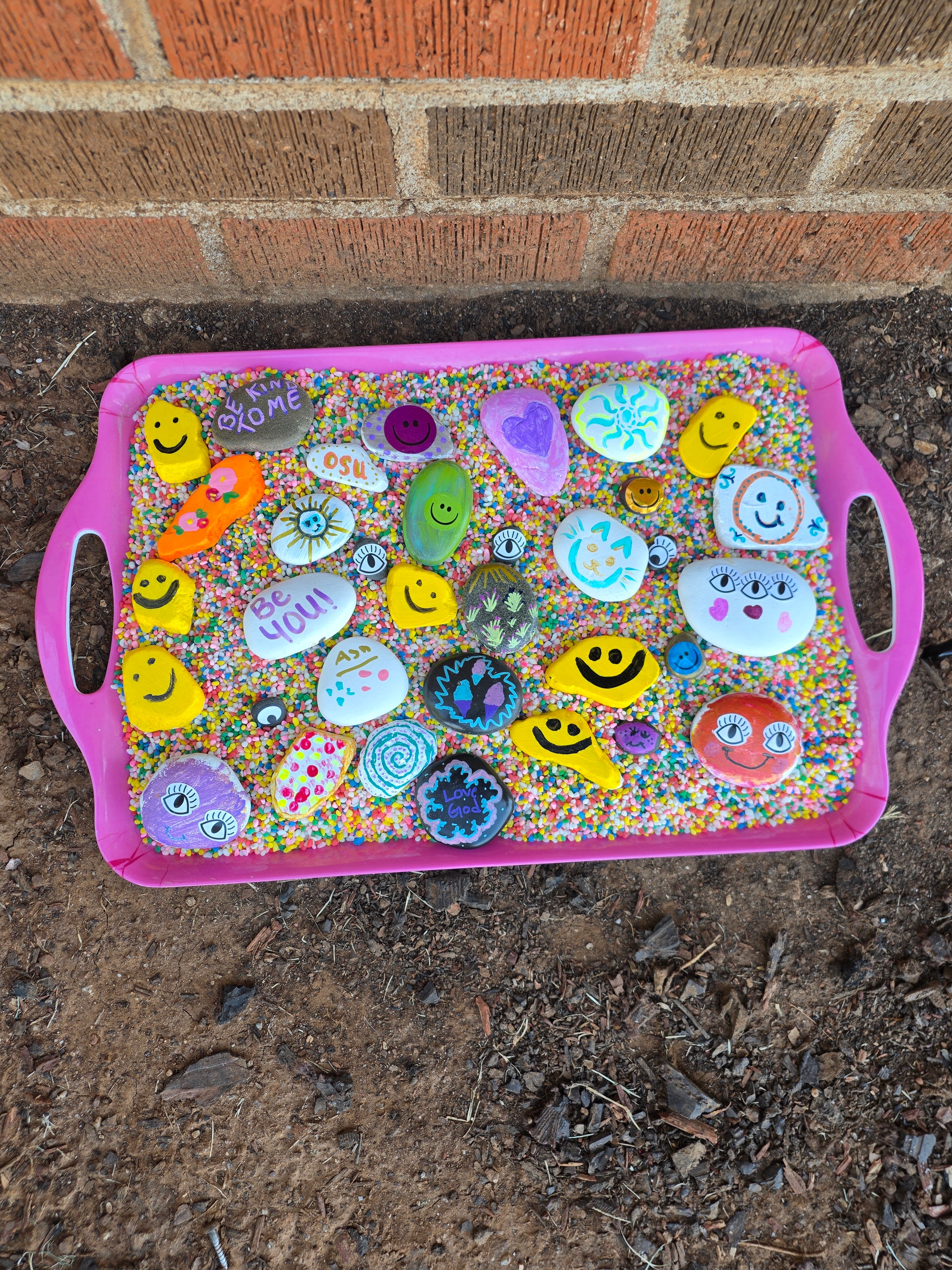 Tray of painted rocks made by students at Focus Microschool